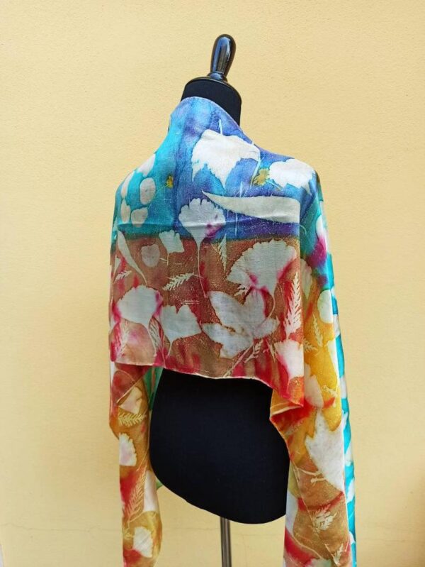 Blue and yellow hand dyed 100% silk scarf with imprinted leaves and flowers. Original colorful accessory to complete any outfit.
