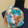 Blue and yellow hand dyed 100% silk scarf with imprinted leaves and flowers. Original colorful accessory to complete any outfit.