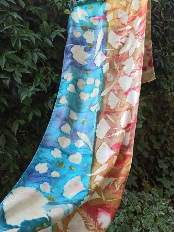 Blue and yellow hand dyed 100% silk scarf with imprinted leaves and flowers. Original colorful accessory to complete any outfit.